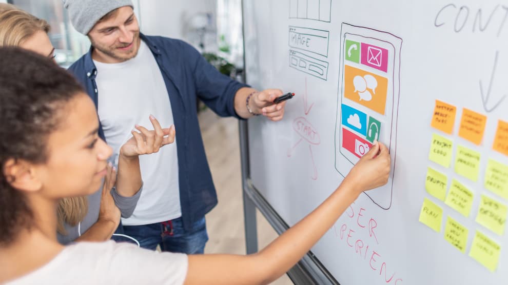 people discussing construction marketing strategy in front of a white board