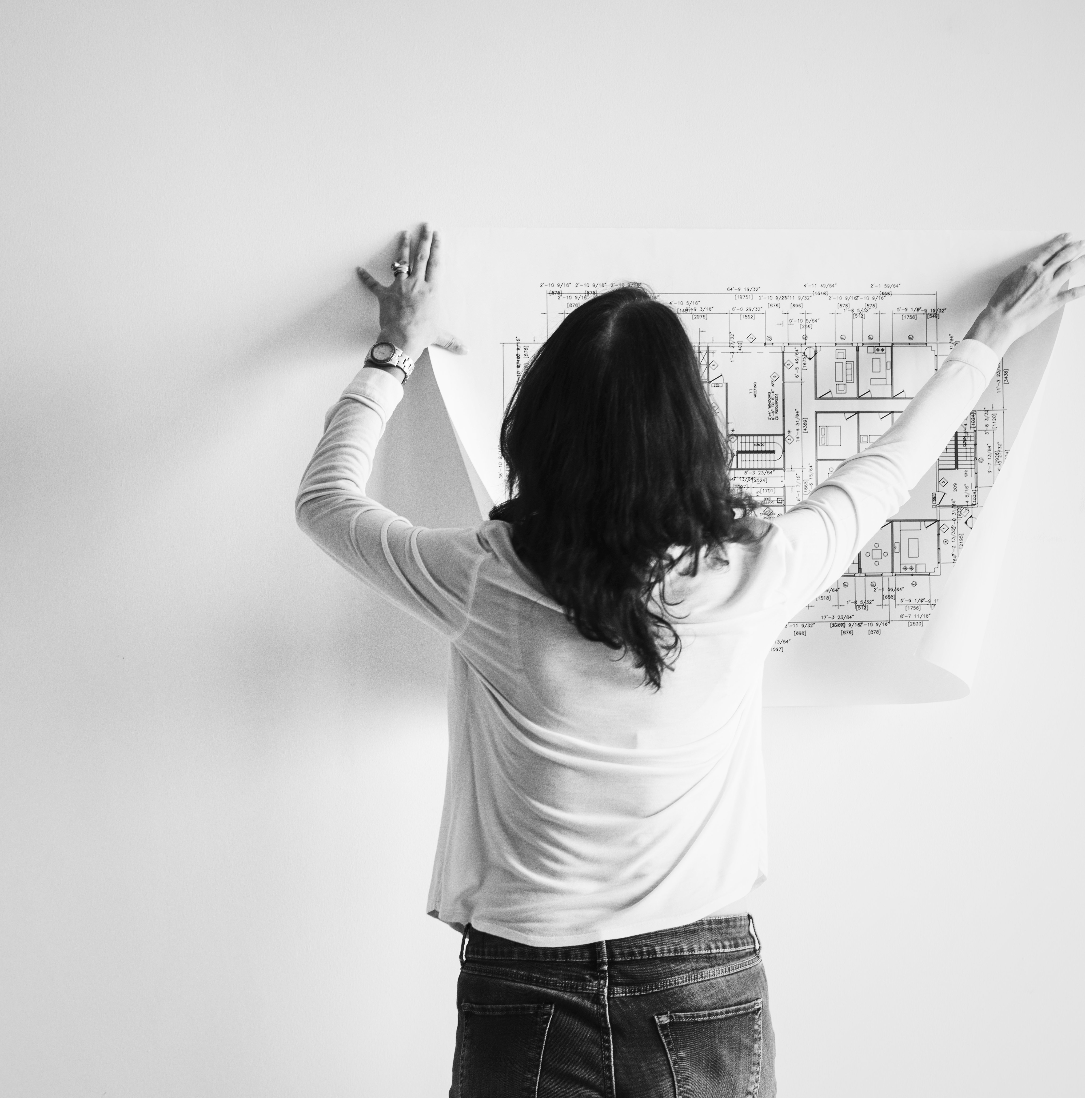 architect putting blueprint on the wall